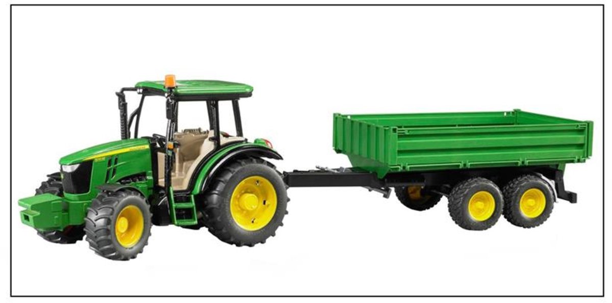 Green toy tractor with trailer on a white background