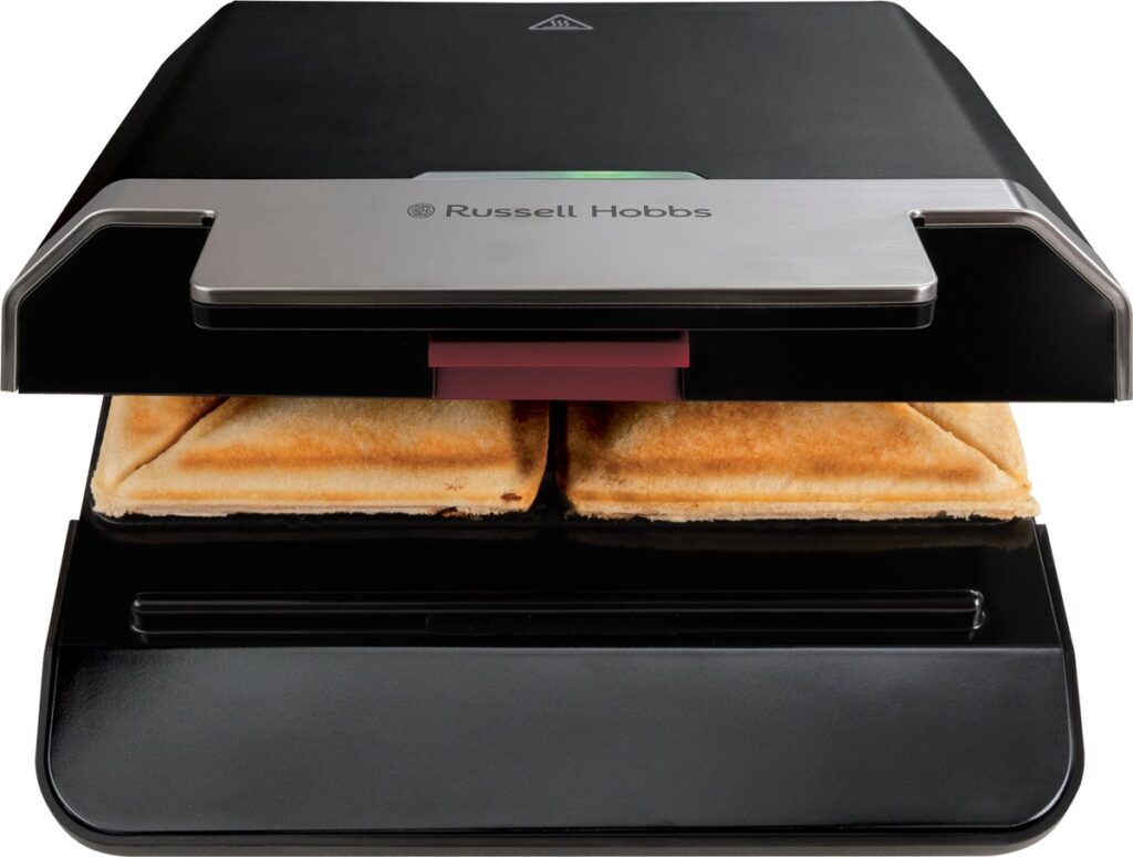 Sandwichmaker met twee gebakken tosti's.