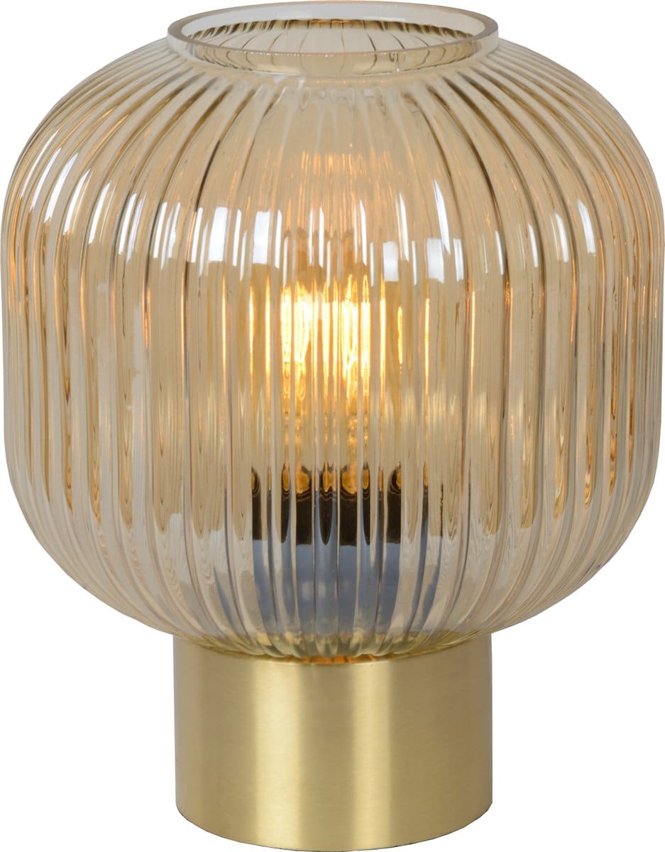 Glazen tafellamp met gouden voet en lichtgevende gloed.