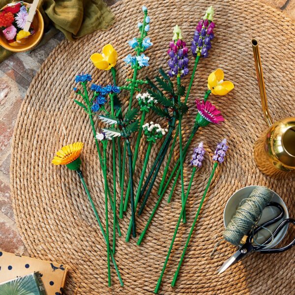 Gekleurde plastic bloemen op een ronde gevlochten mat.