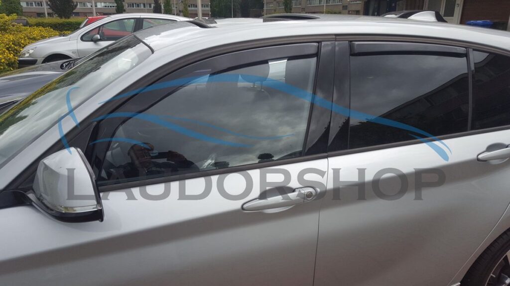 Silver car with side window deflectors