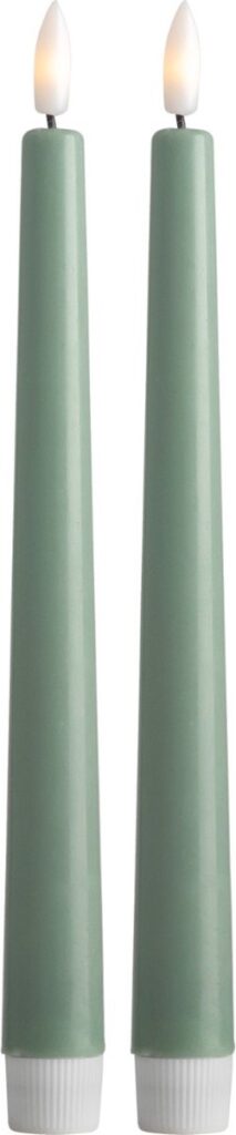 Two green candles with flames