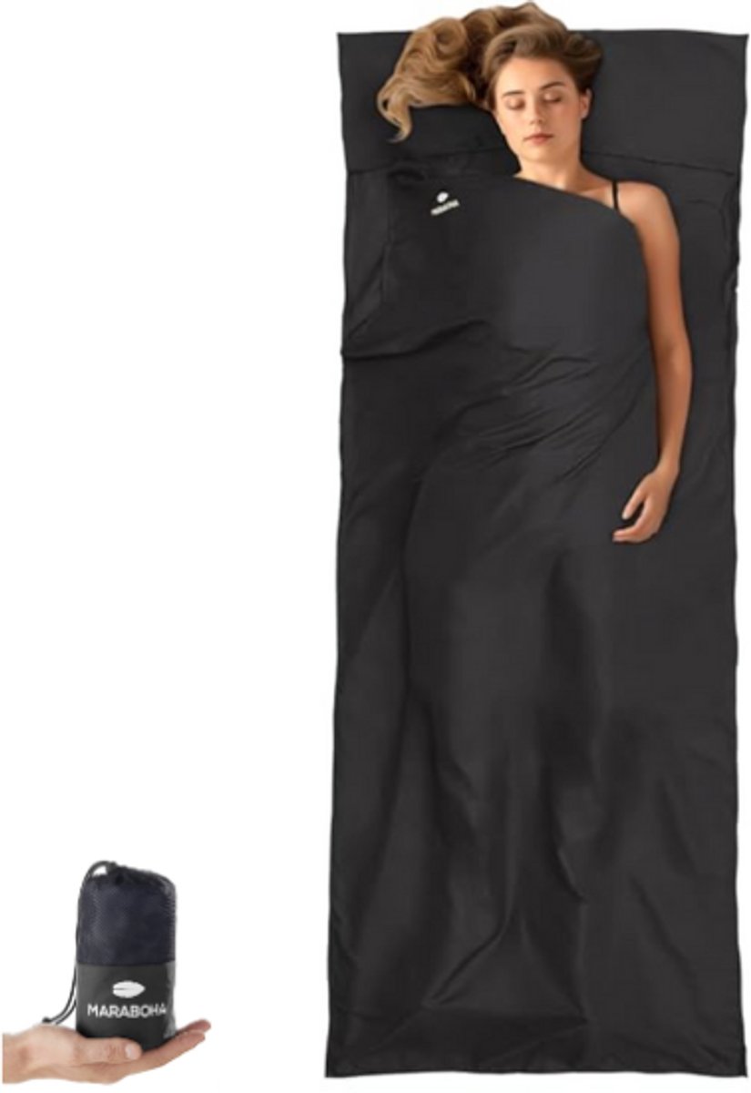 Woman sleeping in a black travel sleeping bag with a storage bag