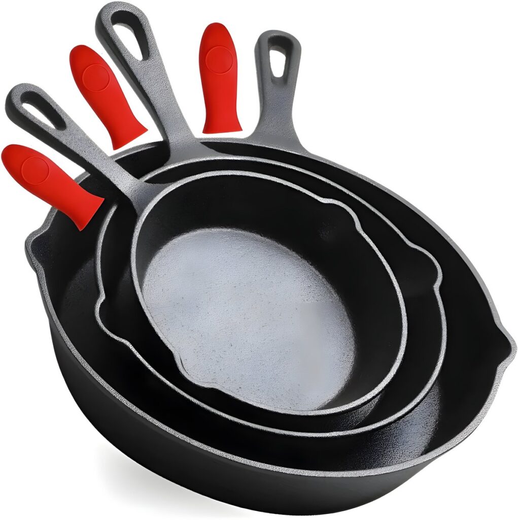 Three cast-iron frying pans with red handles